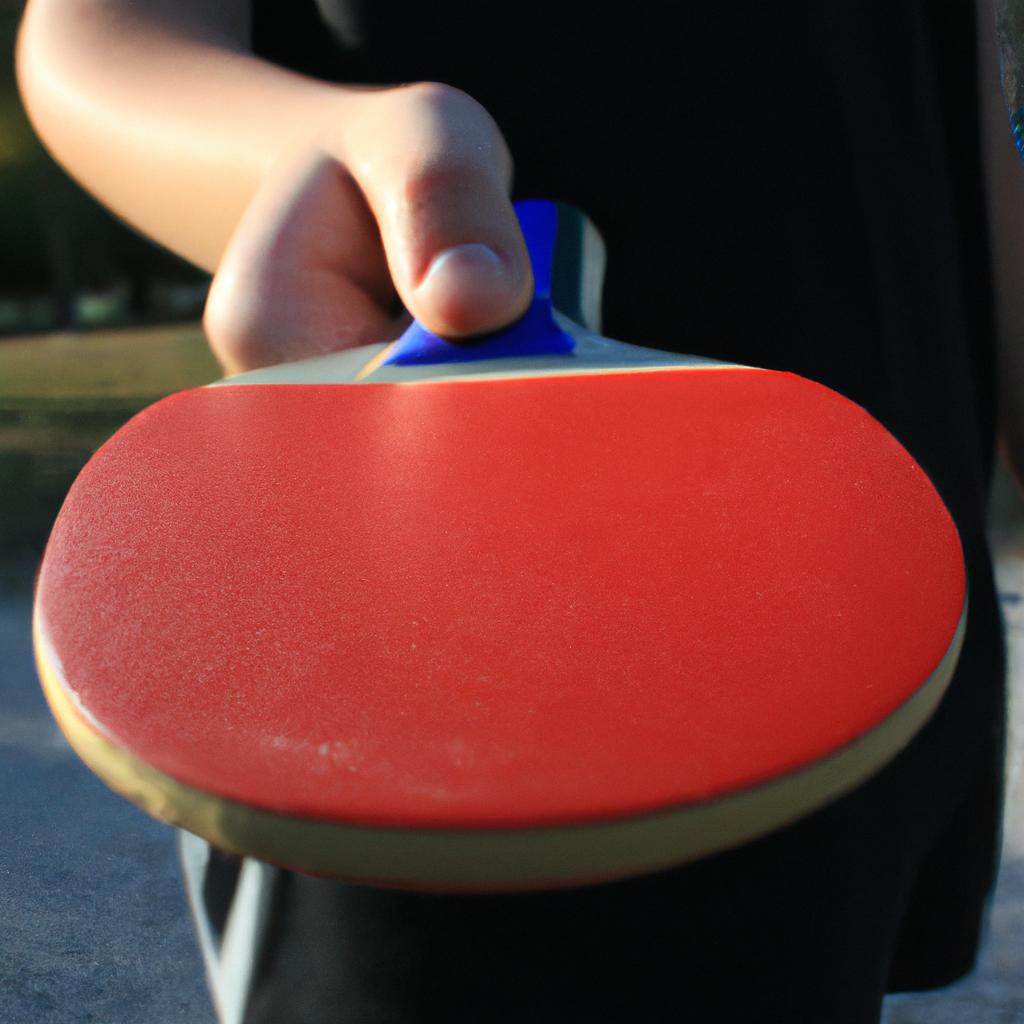 Person holding table tennis paddle
