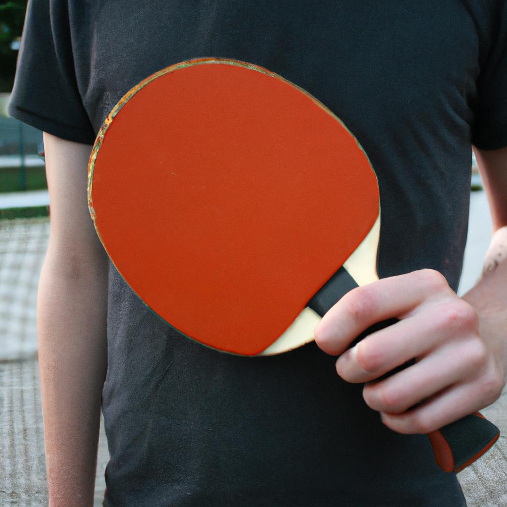 Person holding table tennis racket