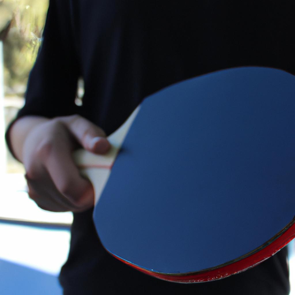 Person holding a ping pong paddle