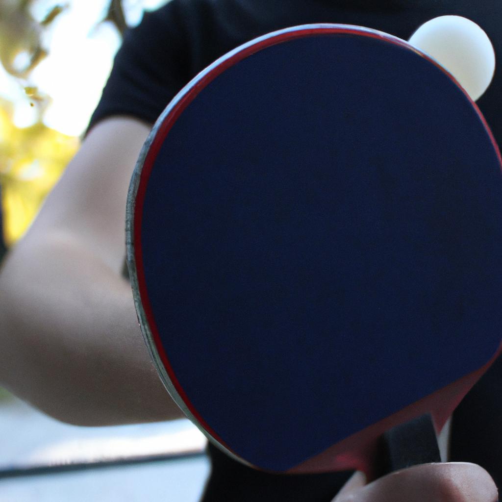 Person holding ping pong paddle
