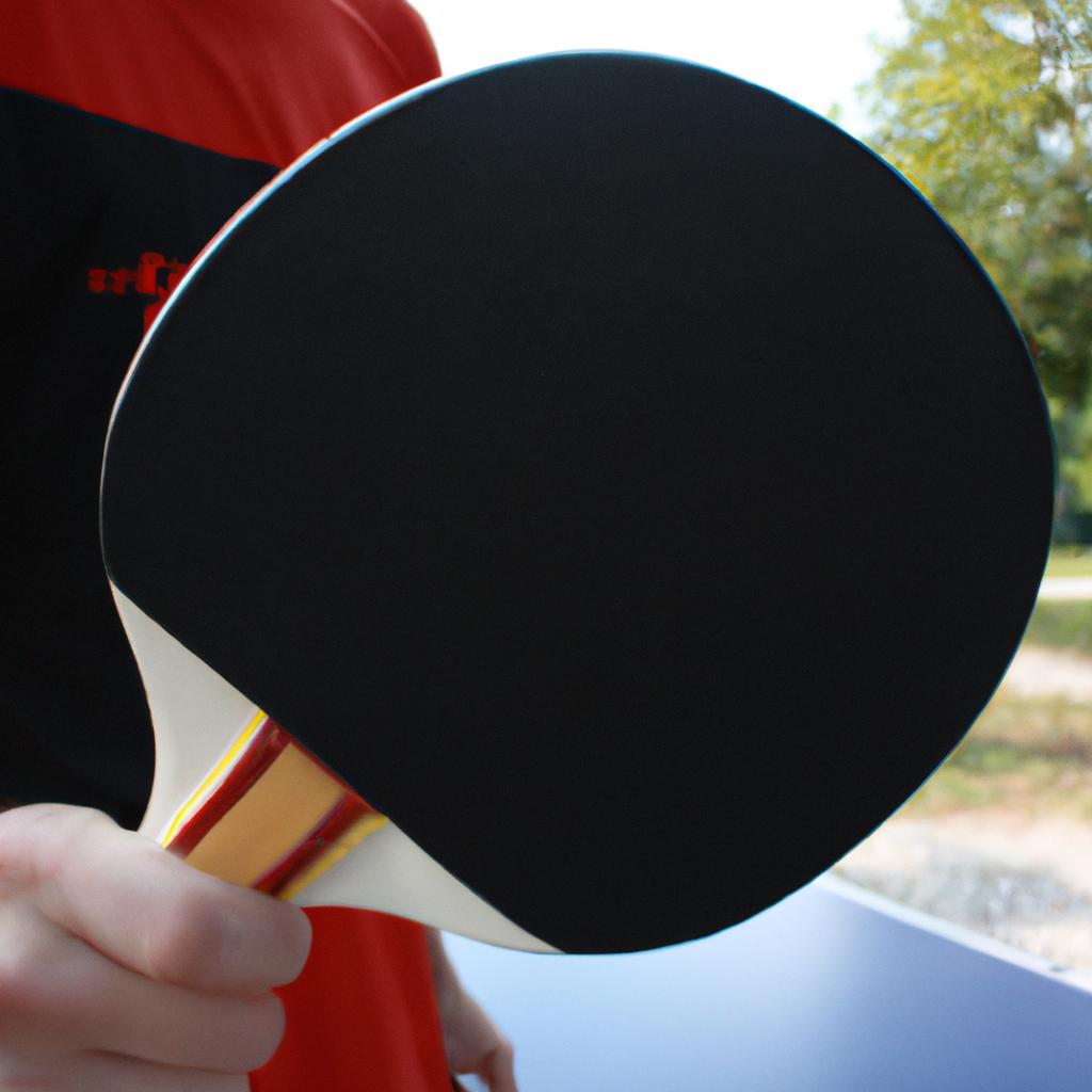 Person holding table tennis paddle